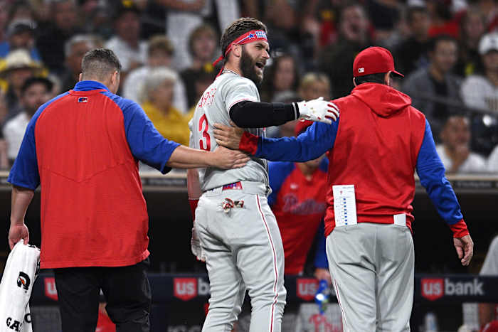 Bryce Harper is helped off the field after getting hit by a pitch from the San Diego Padres' Blake Snell.